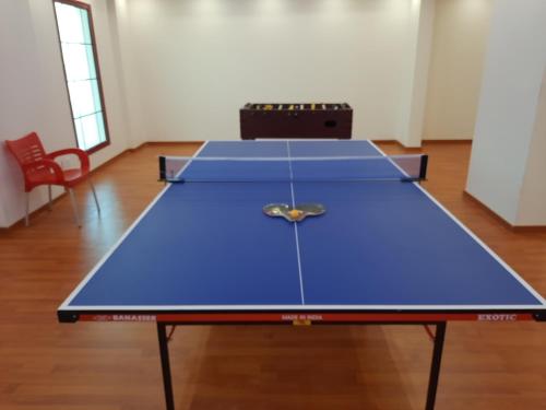 a large blue ping pong table in a room at Villa Park in Al Khobar