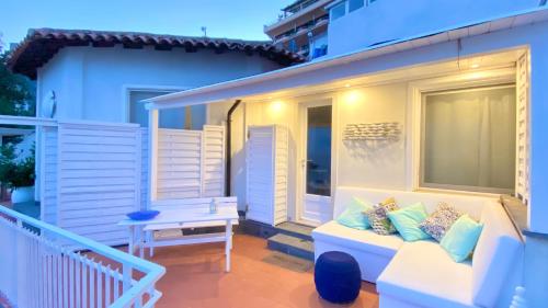 a porch with a white couch on a balcony at Paradisea Taormina in Taormina