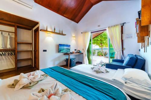 ein Schlafzimmer mit einem großen Bett mit Blumen darauf in der Unterkunft Beach Villa Ukulhas in Ukulhas
