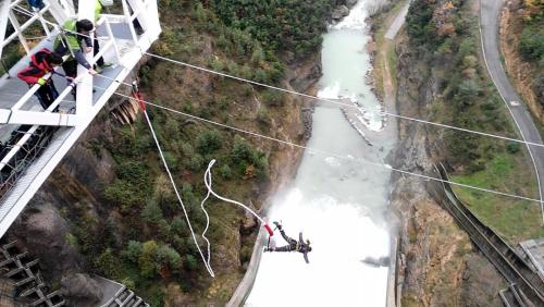 a group of people on a zip line over a river at Lujoso duplex en Port del Comte in La Coma i la Pedra