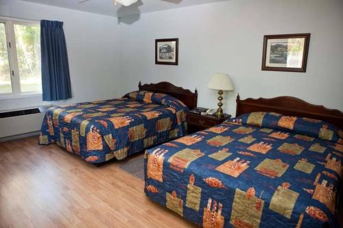 a hotel room with two beds and a window at Clansman Motel in North Sydney