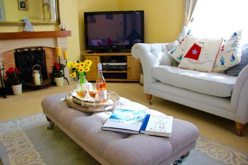 a living room with a couch and a coffee table at Sleeps14 Seaside Luxury House on the Suffolk Coast in Saxmundham