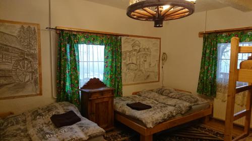 a bedroom with two beds and a window at Chata Zapolanka in Ujsoły