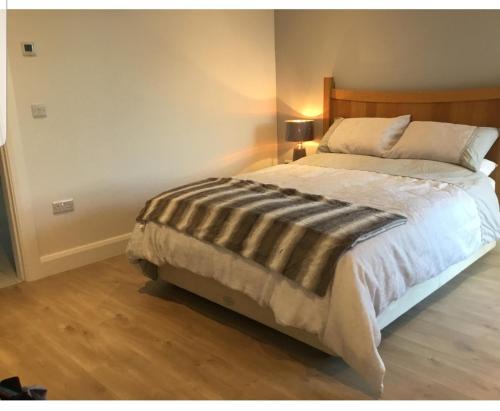 a bedroom with a large bed with a wooden headboard at Country Home in Ratoath