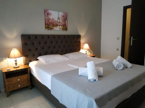 a bedroom with a large bed with towels on it at Ionion Apartments & Studios in Nydri
