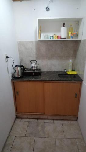 a kitchen counter with a stove and a sink at Dpto PREMA in General Roca