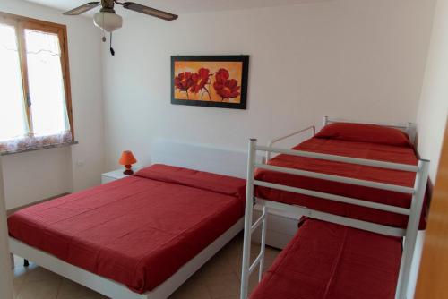 Giường trong phòng chung tại Appartamento il Bucaniere a Marina di Cecina