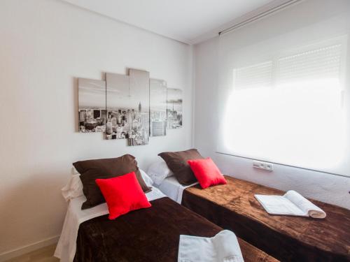 two beds in a room with red pillows at Total Valencia Xàtiva (Leisure & Culture) in Valencia