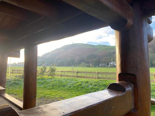 a view of a mountain from a window of a cabin at Log home village in Ulverston