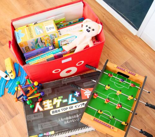 a red box full of toys on the floor at HOUSE K in Ichinomiya