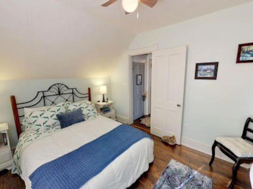 a bedroom with a bed and a ceiling fan at The Blue Bungalow in Montrose