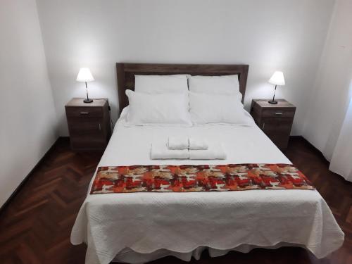 a bedroom with a large bed with two night stands at Piazza Mendoza in Mendoza
