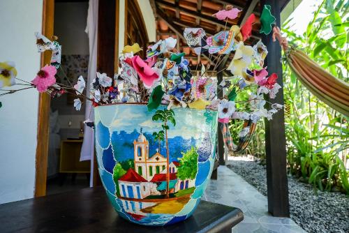 a vase filled with flowers on top of a table at Pousada Chalé Suíço in Paraty