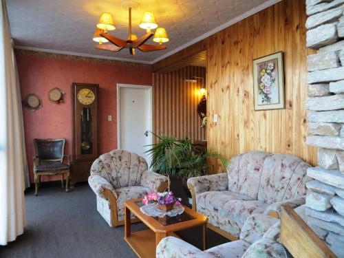 a living room with two couches and a table at Hotel Ritz in Villa Carlos Paz