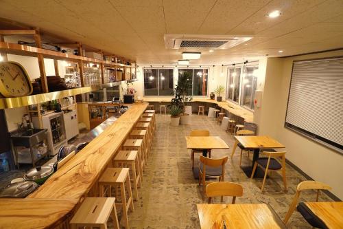 an empty restaurant with wooden tables and chairs at La Union in Fukushima