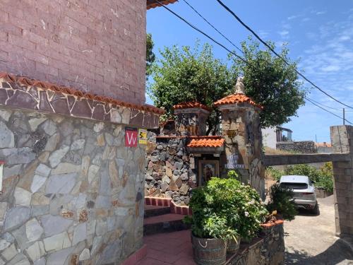 a stone building with some plants in front of it at Casa Arrantzale II in El Cercado