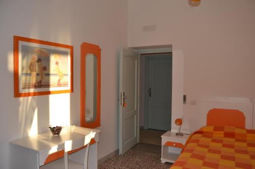 a bedroom with a bed and a table and a desk at Casa Baia Luna in Ponza