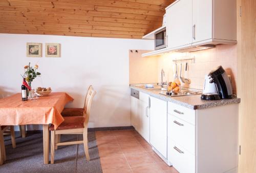a kitchen with a table and a dining room at Denninger's Ferienhäusle in Riezlern