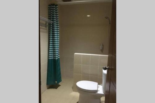 a bathroom with a toilet and a shower at Awana Dream 4 bedrooms house , 5min to Alun Alun, Kraton, Malioboro bdc in Yogyakarta