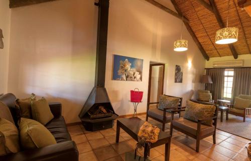 a living room with a couch and a fireplace at Mount Ceder in Cederberg
