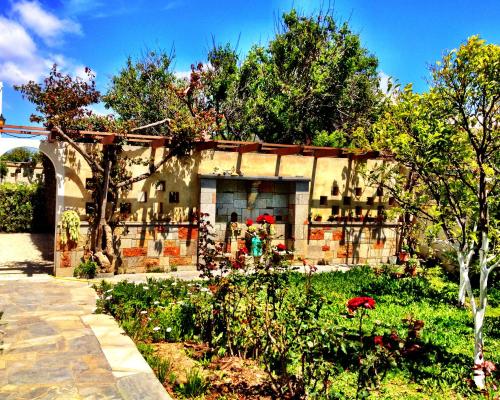 a building with a garden in front of it at Irene Villa in Ierápetra