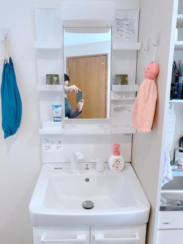 a bathroom with a white sink and a mirror at SKYE HOME in Tokyo