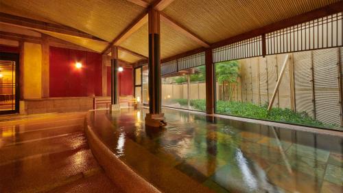 an indoor swimming pool in a building with at Mansuirou in Misasa