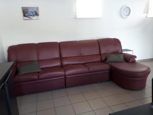 a brown leather couch in a living room at Manege volmolen in Maaseik