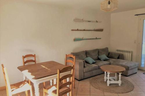 un salon avec un canapé et une table dans l'établissement Maison de vacances 2 chambres wifi à 400 m de la plage, à Les Moutiers