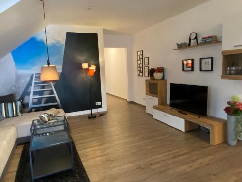 a living room with a couch and a television at Time Out Apartments in Herzogenaurach
