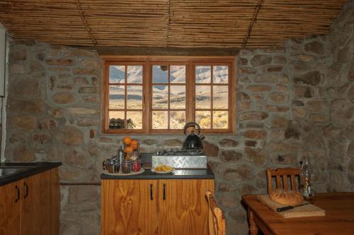 a stone kitchen with a counter and a window at Mount Ceder in Cederberg