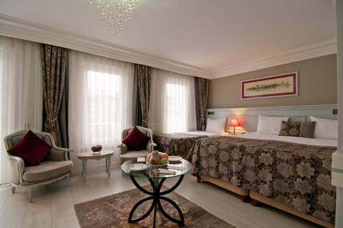 a living room filled with furniture and a large window at Ferman Hotel Old City -Special Category in Istanbul