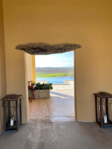 an open door into a room with a view of a pool at Monte da Aparica in Galeguinha Grande