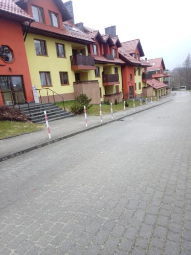 a cobblestone street in front of a row of houses at APARTAMENT LUCYNA in Rabka-Zdrój