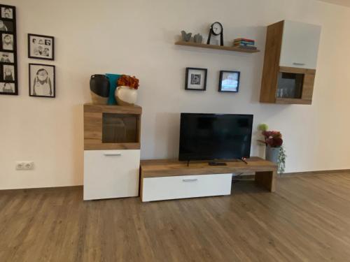 a living room with a flat screen tv on a table at Time Out Apartments in Herzogenaurach
