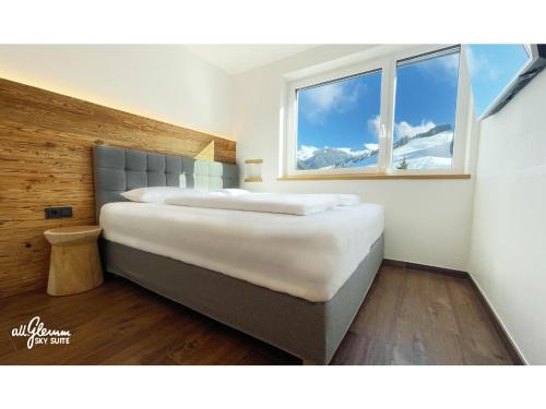 a bedroom with two beds and a window at All.Glemm SKY SUITE in Saalbach Hinterglemm