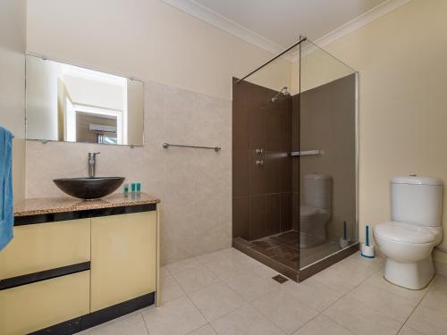 a bathroom with a shower and a sink and a toilet at Seafront Unit 49 in Jurien Bay