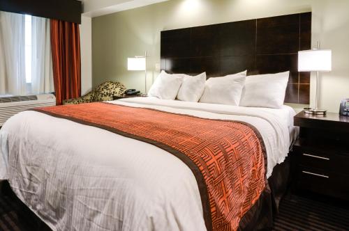 a hotel room with a large bed and a desk at Seaside Inn in San Francisco