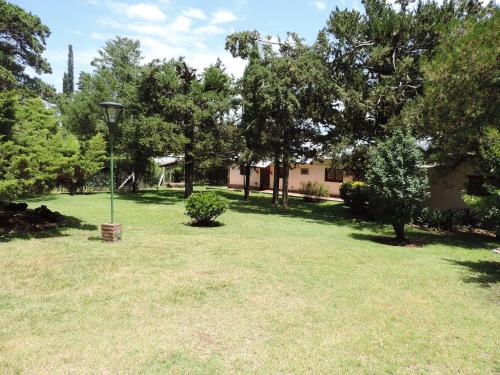 a yard with a light pole in the grass at Hotel Samay Huasi in Villa General Belgrano