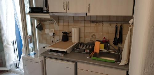 a small kitchen with a sink and a counter top at La Playa Studio Best location close to the Beach & center in Platis Yialos Mykonos