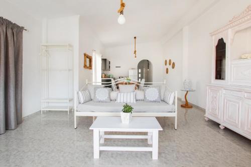 a living room with a couch and a table at Amalthia Apartment in Karpathos Town