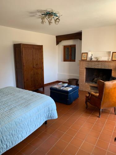 a bedroom with a bed and a fireplace at L'edicola di Ripalvella in San Venanzo