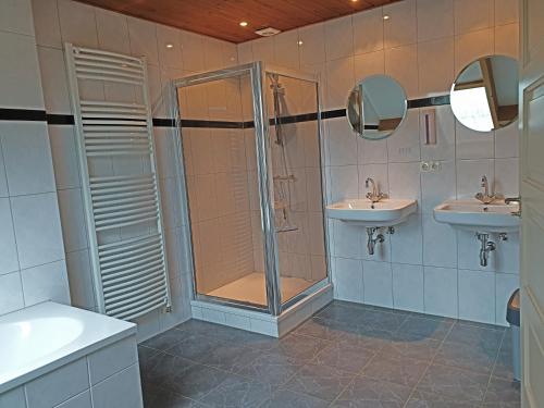 a bathroom with two sinks and a shower at Herlaeve # Korenbloom in Mechelen
