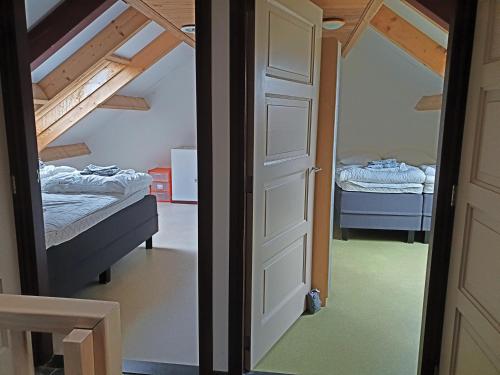 a door leading into a bedroom with two beds at Herlaeve # Korenbloom in Mechelen