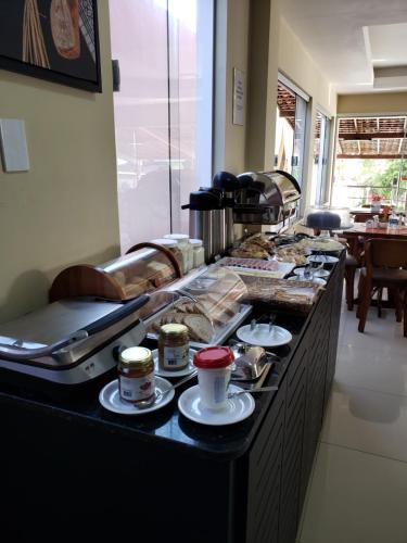 a buffet line with a lot of food on it at Pousada Litorânea in São Luís