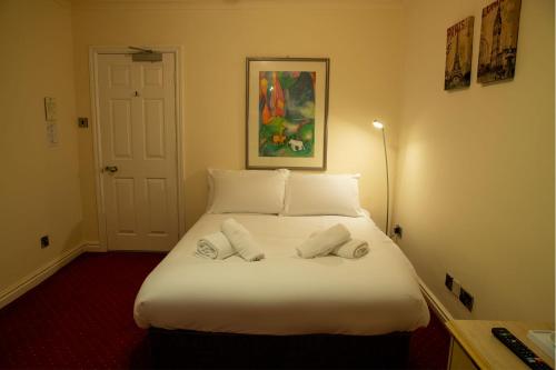 a bedroom with a bed with two pillows on it at The Knighton Hotel in Knighton