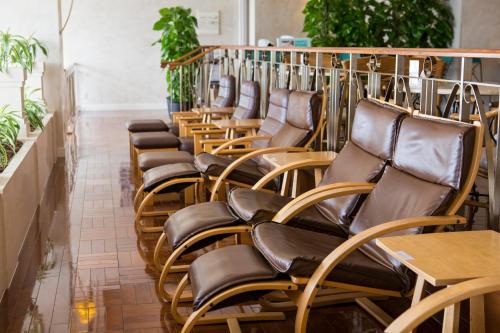 a row of chairs in a room with plants at Hotel Monterey Edelhof Sapporo in Sapporo