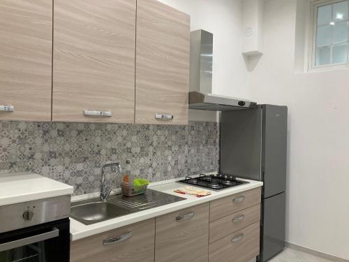a kitchen with a sink and a stove top oven at Il filo di Jordi in Savona