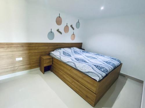 a bedroom with a bed with a wooden headboard at Aqua Blue Lakeview Apartment Ohrid in Peštani