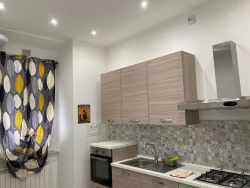 a kitchen with a sink and a stove at Il filo di Jordi in Savona